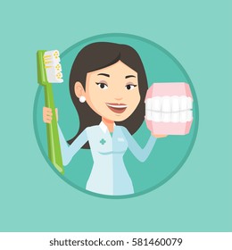 Caucasian dentist holding dental jaw model and a toothbrush in hands. Friendly dentist showing dental jaw model and toothbrush. Vector flat design illustration in the circle isolated on background.