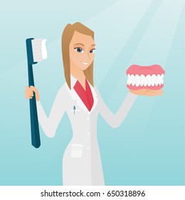 Caucasian dentist showing a dental jaw model and a toothbrush. Young dentist holding a dental jaw model and a toothbrush in hands. Dentistry concept. Vector flat design illustration. Square layout.