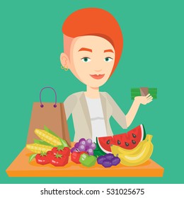 Caucasian female shopper standing at the table with grocery purchases. Young shopper holding money in hand in front of table with grocery purchases. Vector flat design illustration. Square layout.