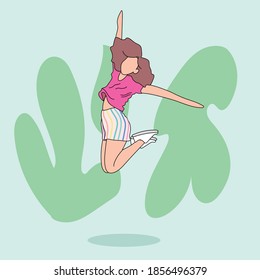 Caucasian girl jumping against the wall. She are having fun.