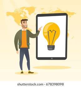 Caucasian man pointing at a big tablet computer with a light bulb on screen. Young hipster man standing near tablet computer on the background of world map. Vector cartoon illustration. Square layout.