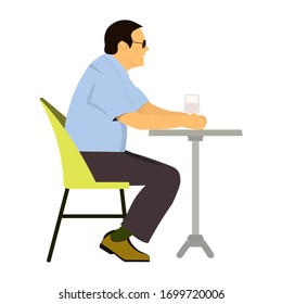 Caucasian man sitting in the bar and drinking a cocktail. Young sad man sitting alone in the bar with a cocktail. Man drinking a cocktail in the bar. 