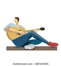 Caucasian musician sitting with the guitar in hands. Hipster man playing the acoustic guitar.