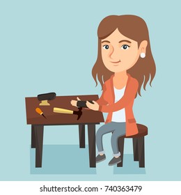 Caucasian shoemaker repairing a shoe in the workshop. Young shoemaker making handmade shoes in the workshop. Female shoemaker working in the workshop. Vector cartoon illustration. Square layout.