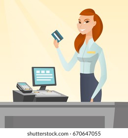 Caucasian smiling cashier standing at the checkout and holding a credit card. Young cheerful cashier making payment by credit card. Vector flat design illustration. Square layout.