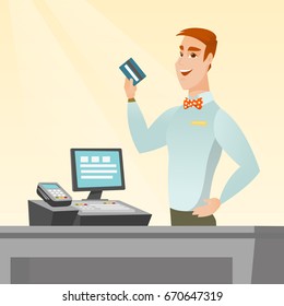 Caucasian smiling cashier standing at the checkout and holding a credit card. Young cheerful cashier making payment by credit card. Vector flat design illustration. Square layout.