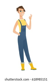 Caucasian smiling farmer in coveralls showing ok sign. Young cheerful farmer making ok sign. Successful happy farmer gesturing ok sign. Vector flat design illustration isolated on white background.