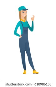 Caucasian smiling mechanic showing ok sign. Full length of young cheerful mechanic making ok sign. Successful mechanic gesturing ok sign. Vector flat design illustration isolated on white background