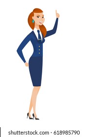 Caucasian stewardess pointing with her finger. Full length of young stewardess pointing her finger up. Stewardess with finger pointing up. Vector flat design illustration isolated on white background.