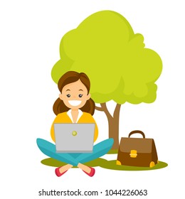 Caucasian white business woman working on a laptop in the park. Young smiling woman sitting under the tree and using a laptop. Vector cartoon illustration isolated on white background. Square layout.