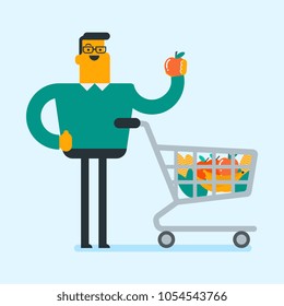 Caucasian white man doing shopping at the grocery shop. Man showing an apple while standing next to the shopping cart full of healthy food from grocery shop. Vector cartoon illustration. Square layout