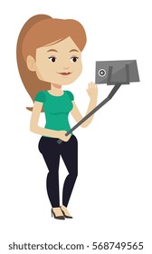 Caucasian woman making selfie with a selfie-stick. Smiling woman making selfie with cellphone. Woman taking selfie and waving her hand. Vector flat design illustration isolated on white background.