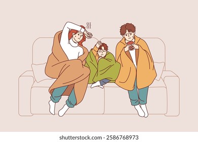 Caught cold family sits on sofa wrapped in blanket and drinks hot tea trying to get rid of virus. Caught cold couple with child contracted infection causing fever and chills and needs medication