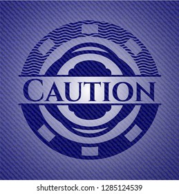 Caution badge with denim background