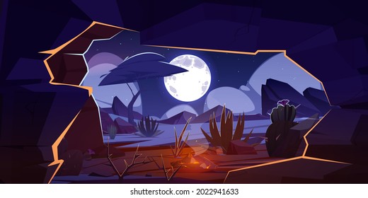 Cave with bonfire and night desert landscape.