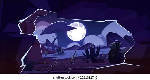 Cave in rock and desert landscape at night