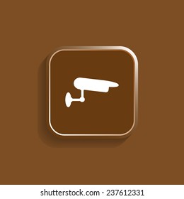 CCTV camera on a brown background with shadow