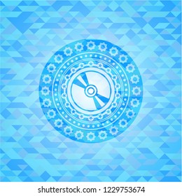 CD or disc icon inside light blue emblem with triangle mosaic background
