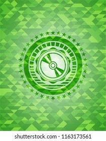 CD or DVD disc icon inside green mosaic emblem