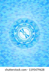 CD or DVD disc icon inside light blue emblem with triangle mosaic background