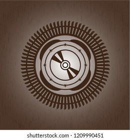 CD or DVD disc icon inside wooden emblem