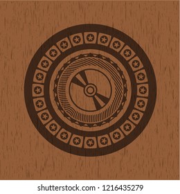 CD or DVD disc icon inside retro wood emblem