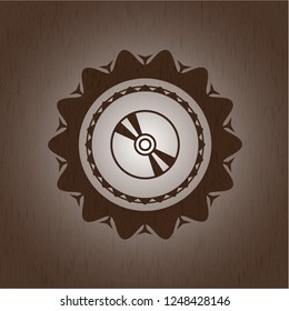 CD or DVD disc icon inside retro style wooden emblem