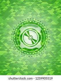 CD or DVD disc icon inside green emblem with triangle mosaic background