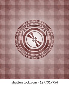 CD or DVD disc icon inside red seamless emblem or badge with abstract geometric polygonal pattern background.