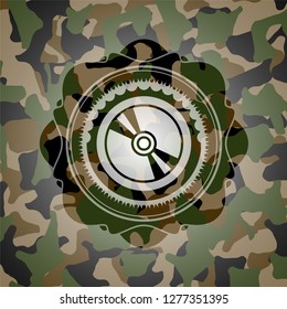 CD or DVD disc icon inside camouflaged emblem