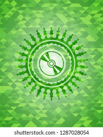CD or DVD disc icon inside green emblem with triangle mosaic background