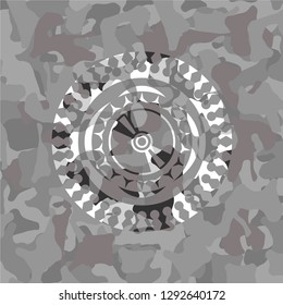 CD or DVD disc icon inside grey camouflaged emblem
