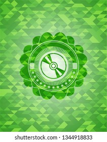 CD or DVD disc icon inside green emblem with triangle mosaic background