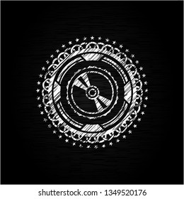 CD or DVD disc icon inside chalk emblem written on a blackboard