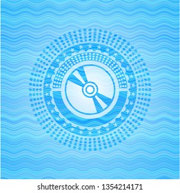 CD or DVD disc icon inside water concept style emblem.