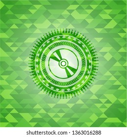 CD or DVD disc icon inside green emblem with mosaic background