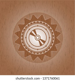 CD or DVD disc icon inside wooden emblem. Retro