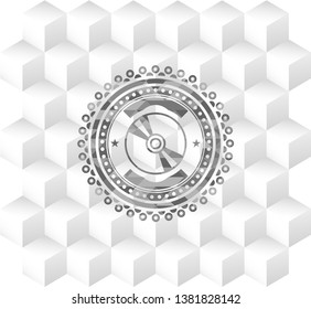 CD or DVD disc icon inside grey emblem with geometric cube white background