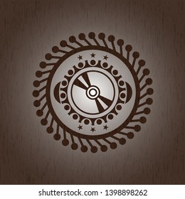 CD or DVD disc icon inside retro wooden emblem