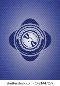 CD or DVD disc icon inside badge with denim background