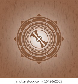 CD or DVD disc icon inside realistic wood emblem