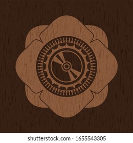 CD or DVD disc icon inside badge with wooden background