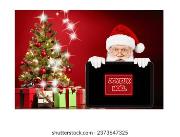 Celebrate Christmas in a warm and connected atmosphere with this design. A Christmas background features a Christmas tree, gifts, and Santa Claus holding a tablet. The "Merry Christmas" text adds a fe