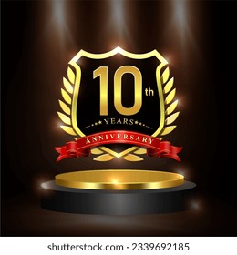 Celebrating 10 years anniversary logo with golden shield and ribbon, laurel wreath, cylinder podium vector design.