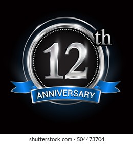 Celebrating 12th anniversary logo. with silver ring and blue ribbon.