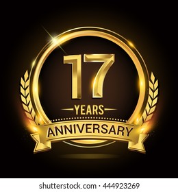 Celebrating 17 years anniversary logo with golden ring and ribbon, laurel wreath vector design.