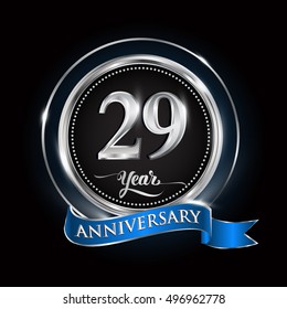 Celebrating 29 years anniversary logo. with silver ring and blue ribbon.