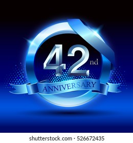 Celebrating 42nd anniversary logo, with silver ring and blue ribbon isolated on black  background.