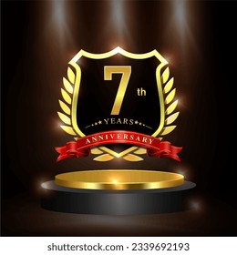 Celebrating 7 years anniversary logo with golden shield and ribbon, laurel wreath, cylinder podium vector design.