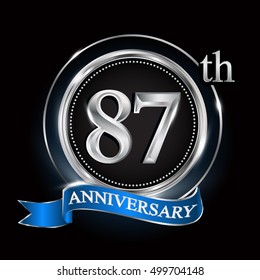 Celebrating 87th anniversary logo. with silver ring and blue ribbon.